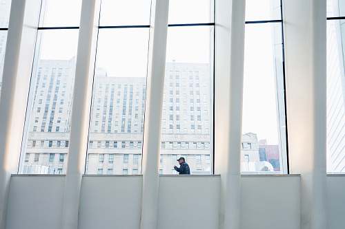human man standing near glass wall person